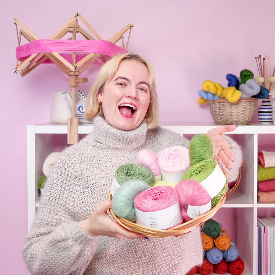 Luisa holding a basket of Hobbii yarns